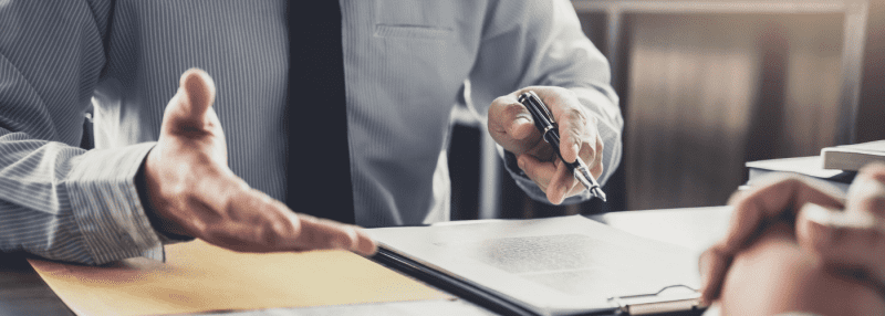 man in a suit with a pen in his hand